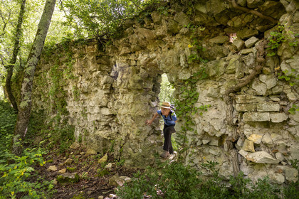 France, Vaucluse, Dentelles de Montmirail mountains, Sablet, hiker on the ruined site of a 7th-century abbey of nuns in the Prébayon valley