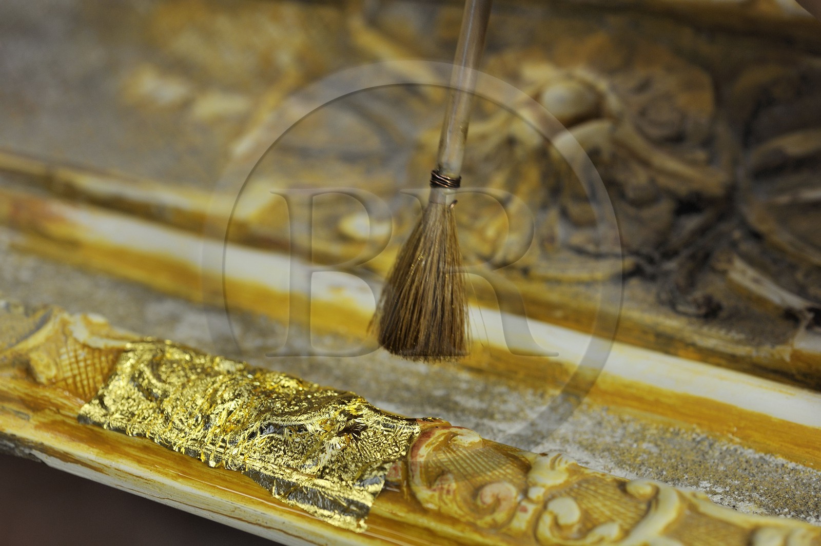 France, Yvelines, Chateau de Versailles, the castle restoration workshop, gilt workshop, Laurent Hissier working on a frame