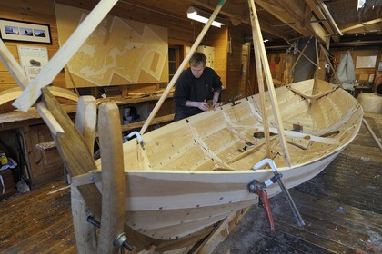 Norway, Hordaland County, Norheimsund, Fartoyvernsenter Boat Preservation Centre, renovation workshop, wooden boat with oar traditionally built by Bjorn Kvalvik