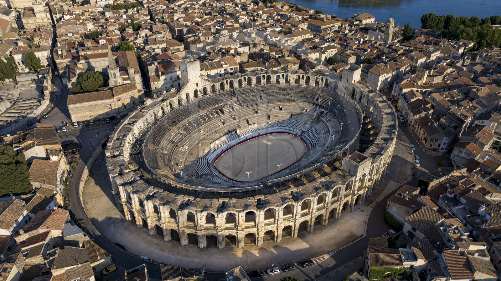 France, Bouches du Rhone, Arles, the Arena, a Roman amphitheater built around 80-90 AD, listed as World heritage by UNESCO, in the heart of the old town and the Rhone river in the background (aerial view)