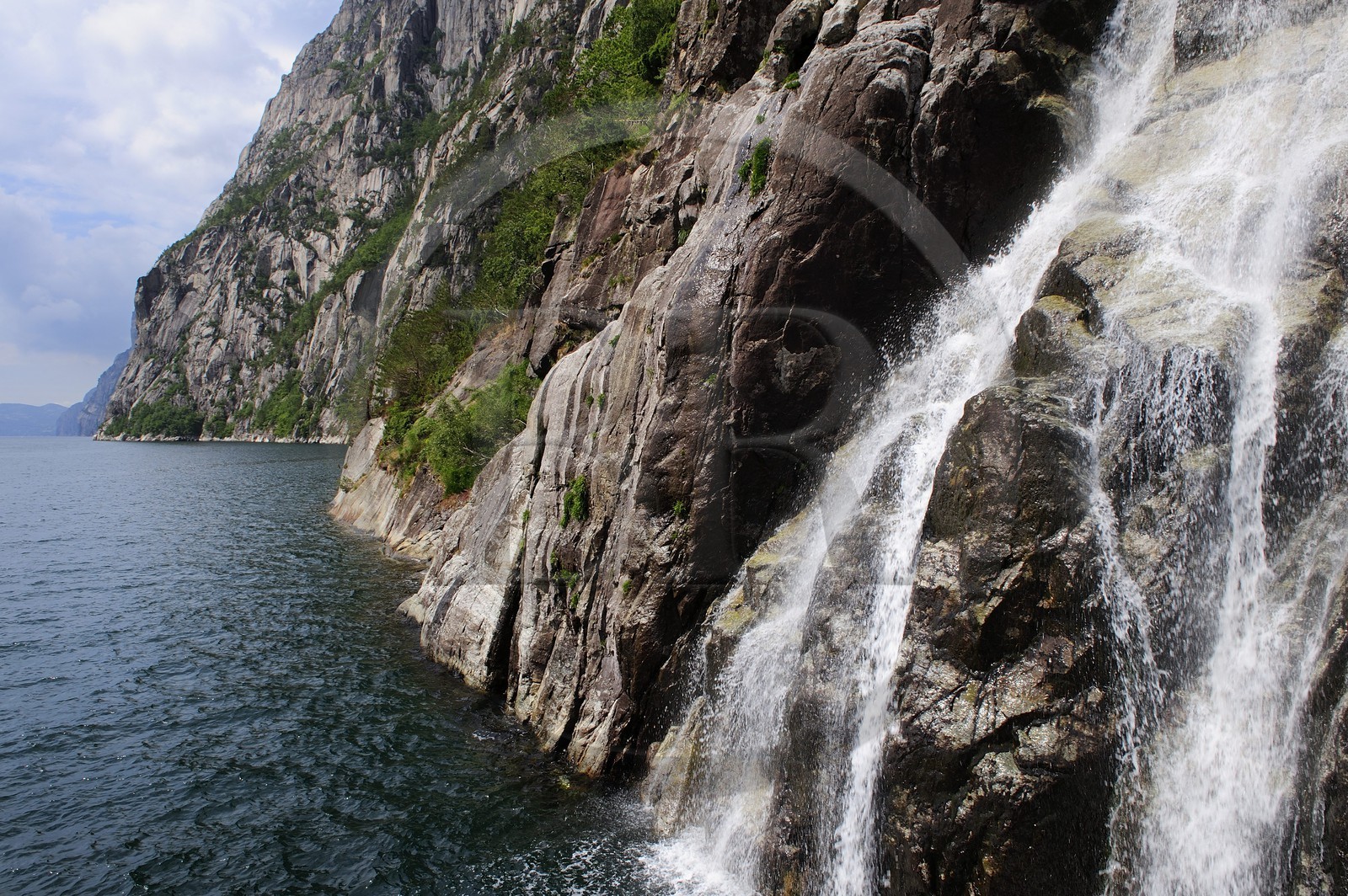 Norway, Rogaland County, Lysebotn Fjord, waterfall falling in the Lysefjord