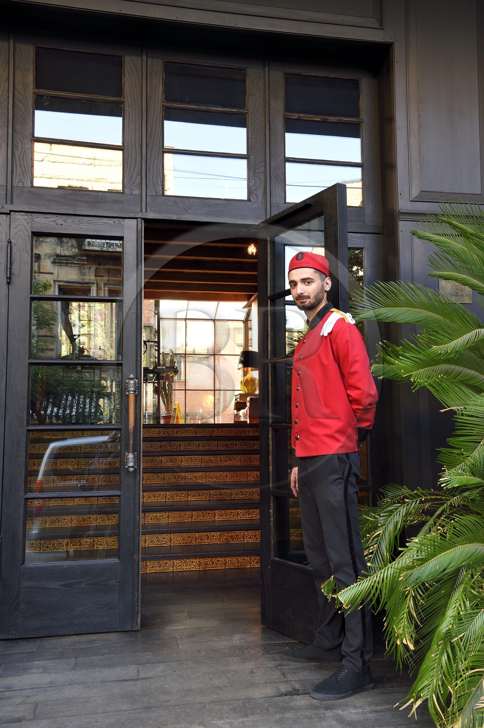 Georgia, Tbilisi, bellboy at the entrance of the Rooms hotel