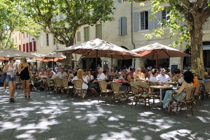 France, Gard, Uzes, listed as town of art and history, the Place aux Herbes surrounded by arcaded houses and its outdoor cafes