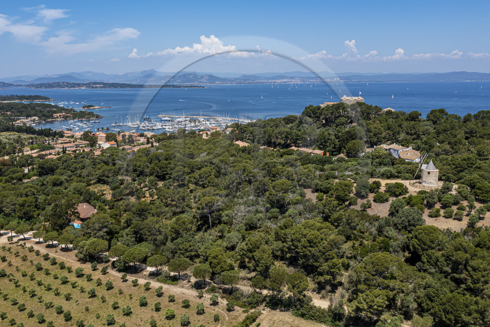 France, Var, Iles d'Hyeres, Parc National de Port Cros (National park of Port Cros), Porquerolles island, the windmill, the village and harbor of Porquerolles overlooked by the castle Sainte-Agathe (aerial view)