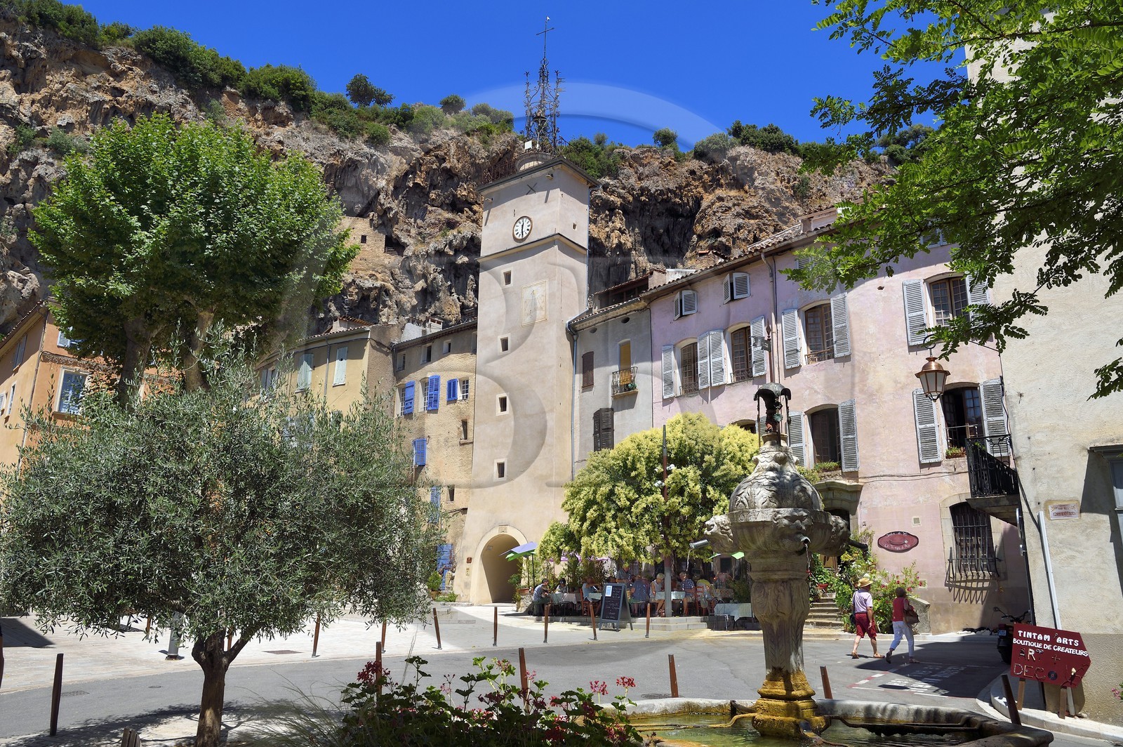 France, Var, Provence Verte, Cotignac, the Town Hall Square and the Clock tower below the tufa cliff of 80 meters high and 400 meters wide