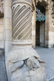 Spain, Catalonia, Barcelona, Eixample district, Sagrada Familia basilica by Catalan modernist architect Antoni Gaudi, listed as a UNESCO World Heritage Site, turtle supporting one of the columns of the Porte de la Charité