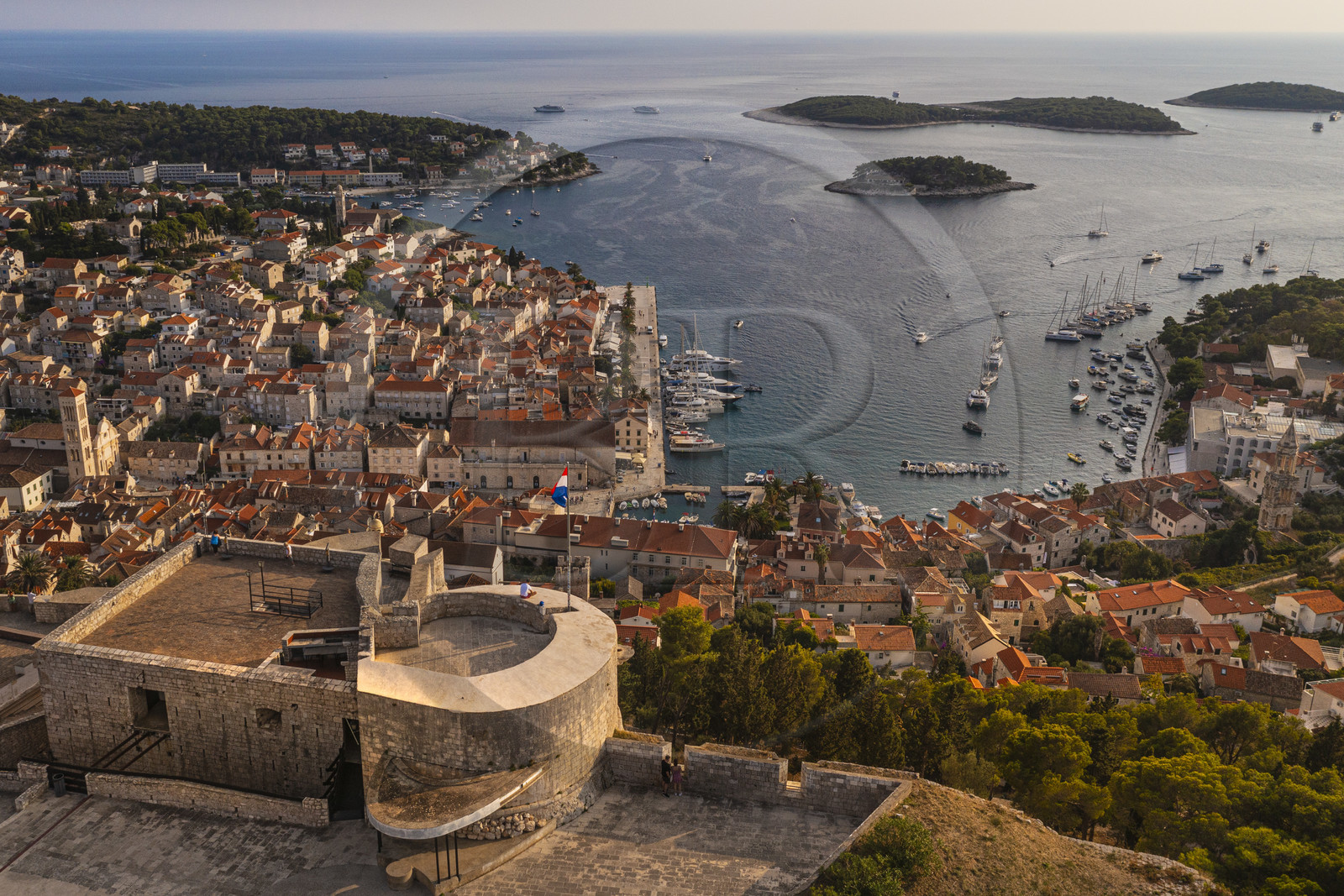 Croatia, Dalmatia, Dalmatian coast, Island of Hvar, the town of Hvar dominated by its Spanish Fortress and the Infernal Islands in the background (aerial view)