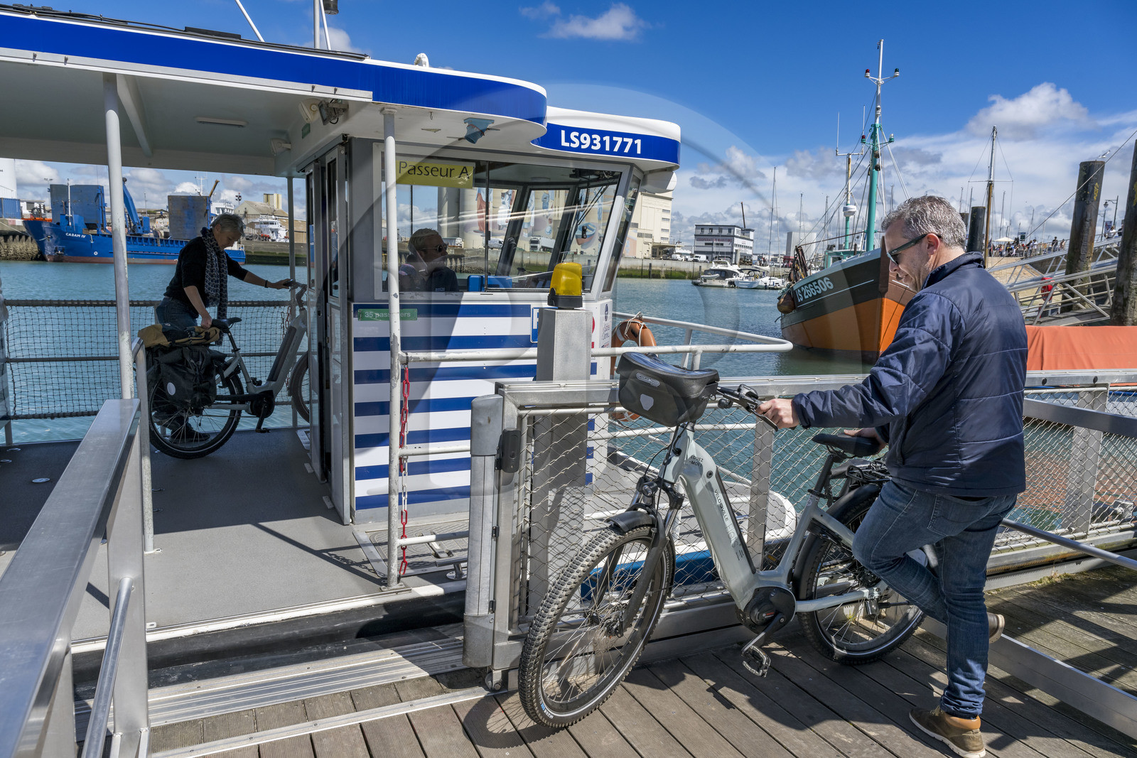 France, Vendee, Les Sables d'Olonne, cyclists using the ferry crossing the port
