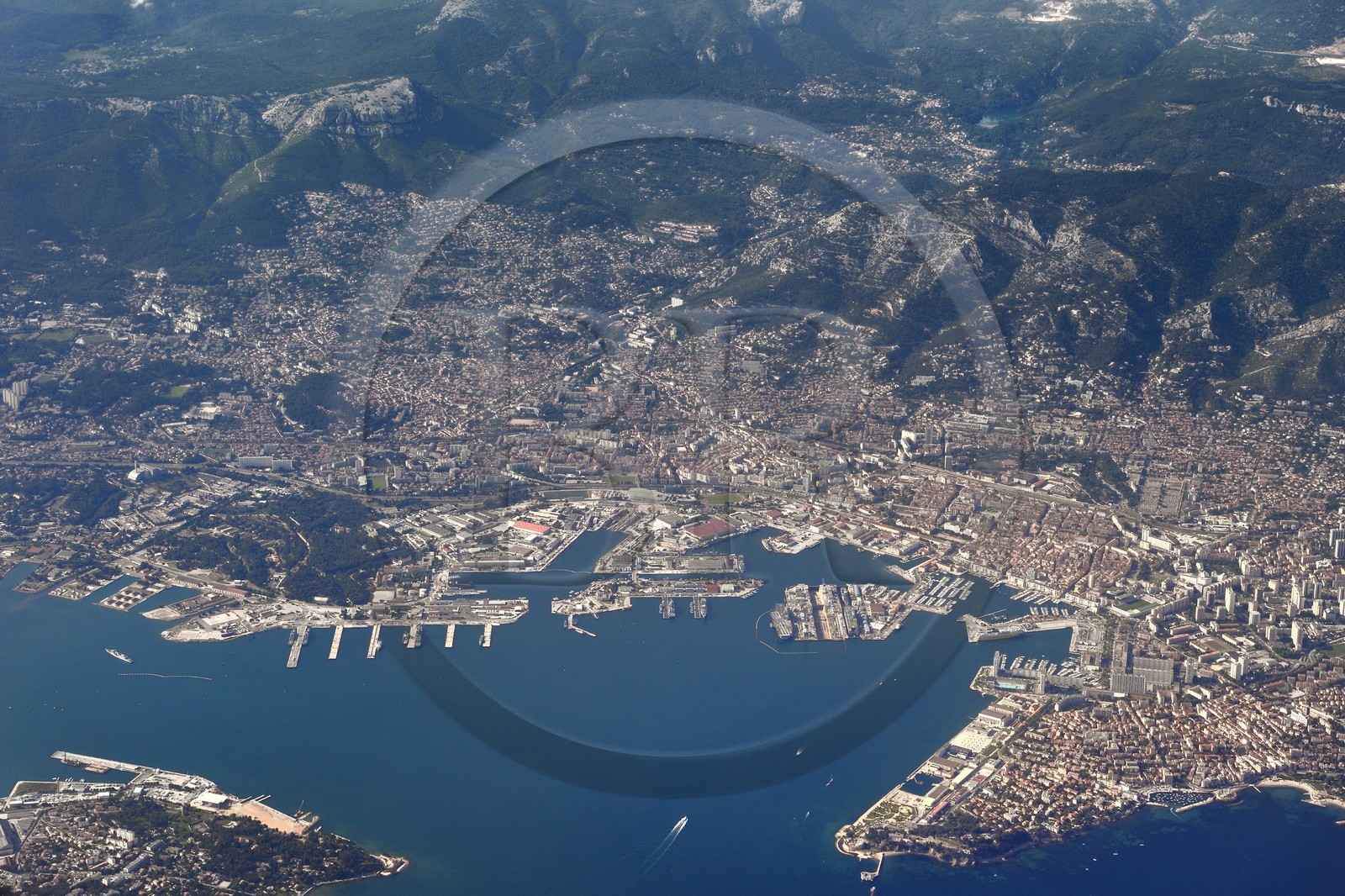 France, Var, the Rade (harbor) of Toulon, the naval base (Arsenal) surrounded by the city and Mount Farron in the background right (aerial view)