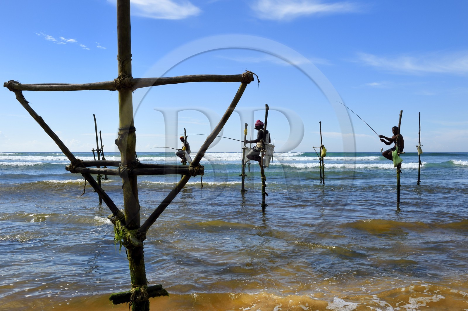 Sri Lanka, Southern Province, Galle district, Midigama beach, Pole Fishermen or Stilt Fishermen ply their trade along the Galle coastline
