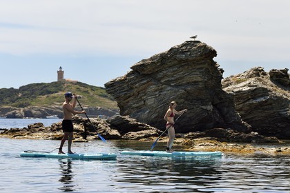 France, Var, Six Fours les Plages, Ile des Embiez, cape Saint Pierre, Freestyle windsurfing champion Adrien Bosson on a paddle boarding excursion, the Grand Rouveau lighthouse in the background