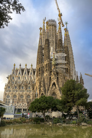 Spain, Catalonia, Barcelona, Eixample district, Sagrada Familia basilica by Catalan modernist architect Antoni Gaudi, listed as a UNESCO World Heritage Site, facade of the Nativity and the cypress symbolizing the Tree of Life