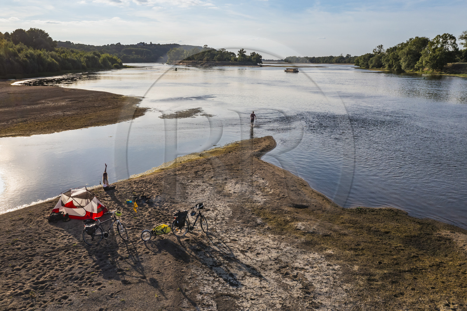 France, Maine-et-Loire, Loire valley listed as World Heritage by UNESCO, cycling along the banks of the Loire, camping for the night on one of the sandbanks forming islands on the Loire, a gabarre (traditional flat-bottomed boat) in the background (aerial view)