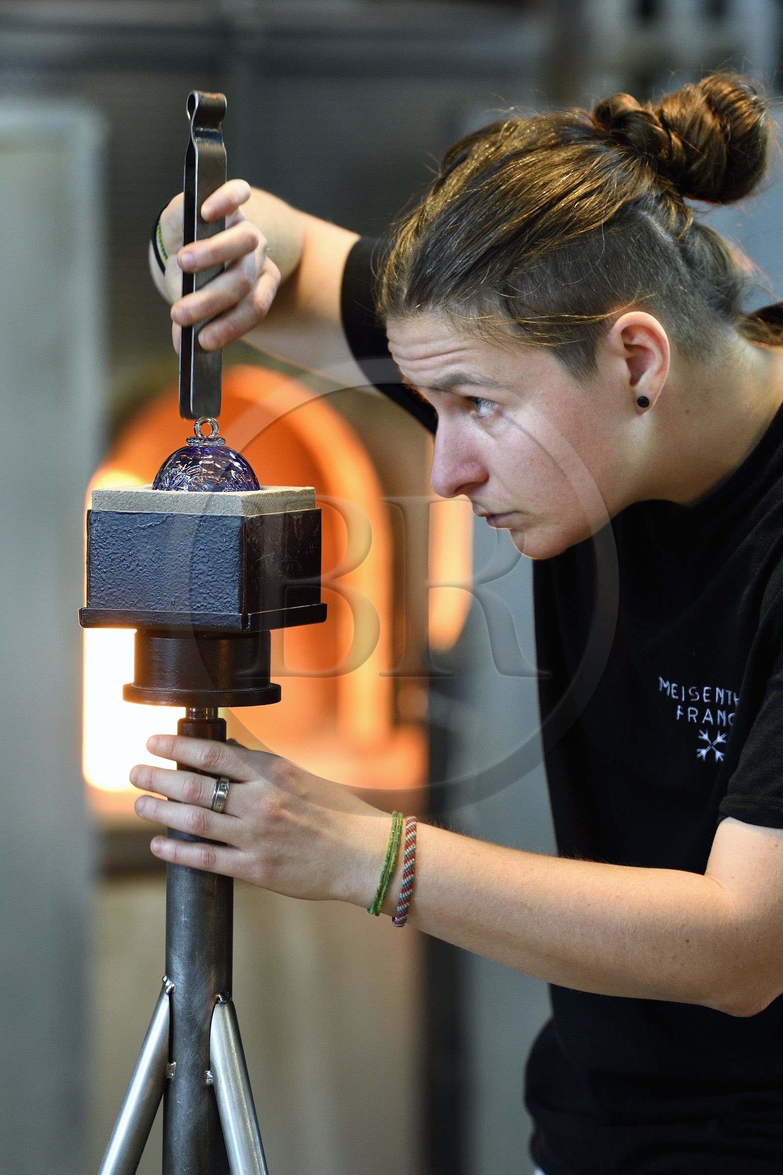 France, Moselle, Meisenthal, Centre international d'Art verrier (CIAV) (international glass centre), the blowing workshop, crafting a Christmas ball, finalization of the installation of the glass hook