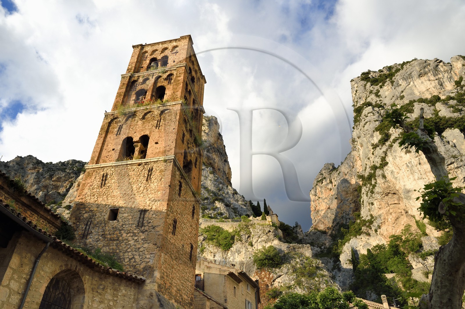 France, Alpes de Haute Provence, Parc Naturel Régional du Verdon, village of Moustiers Sainte Marie, labelled Les Plus Beaux Villages de France (The Most Beautiful Villages of France), the Notre-Dame-de-l'Assomption church with its 12th century bell tower and the Star of Moustier hanging on a chain several tens of meters above the ground
