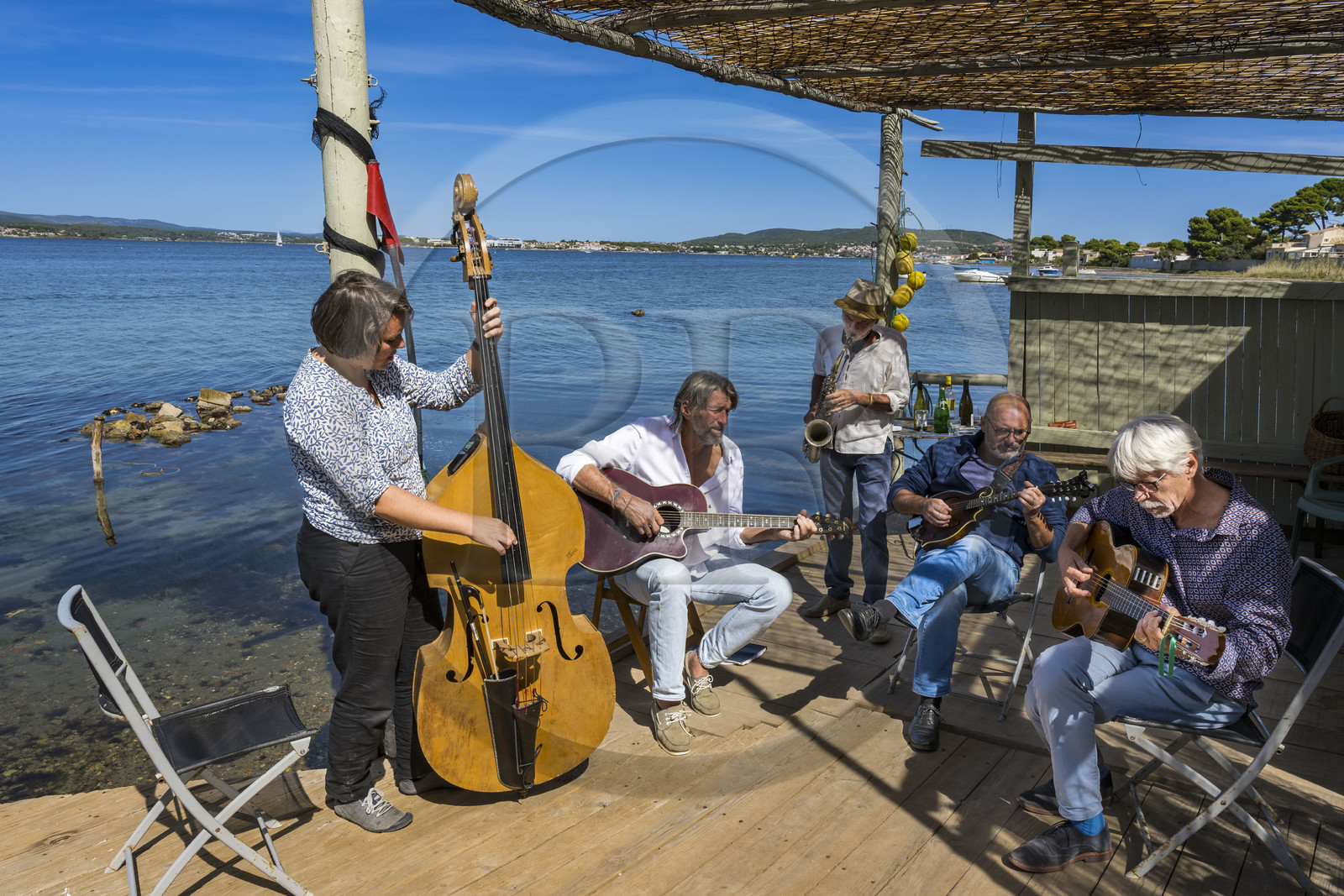France, Hérault (34), Sète,  Pointe du Barrou sur les rives de l'étang de Thau, le groupe de musique Au Bois de mon cœur qui réinterprète les chansons de Georges Brassens, il est mené par le pêcheur sétois Jean-Louis Lambert au chant et à la guitare, Georges Cabaret à la guitare solo, Guy Blanc dit Guet au saxo alto, Denis Benito à la mandoline bluegrass et Tatiana à la contrebasse