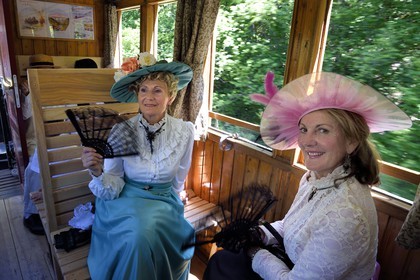 France, Alpes de Haute Provence, between Annot and Saint-Benoit, Train des Pignes historic train, members of the AHVAE (Association d'histoire vivante et de d'archeologie expérimentale) in Belle Epoque costume in a passenger car from 1892