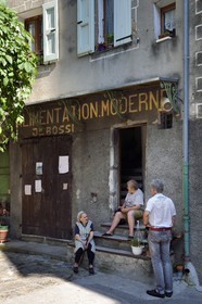 France, Alpes de Haute Provence, Entrevaux Medieval city fortified by Vauban, discussion in front of the old town grocery store in la Porte Royale street