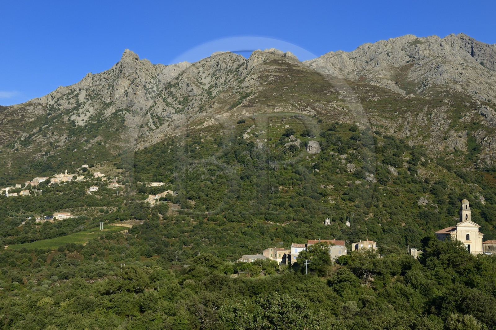 France, Haute Corse, Balagne, Feliceto church and perched village of Nessa in the background
