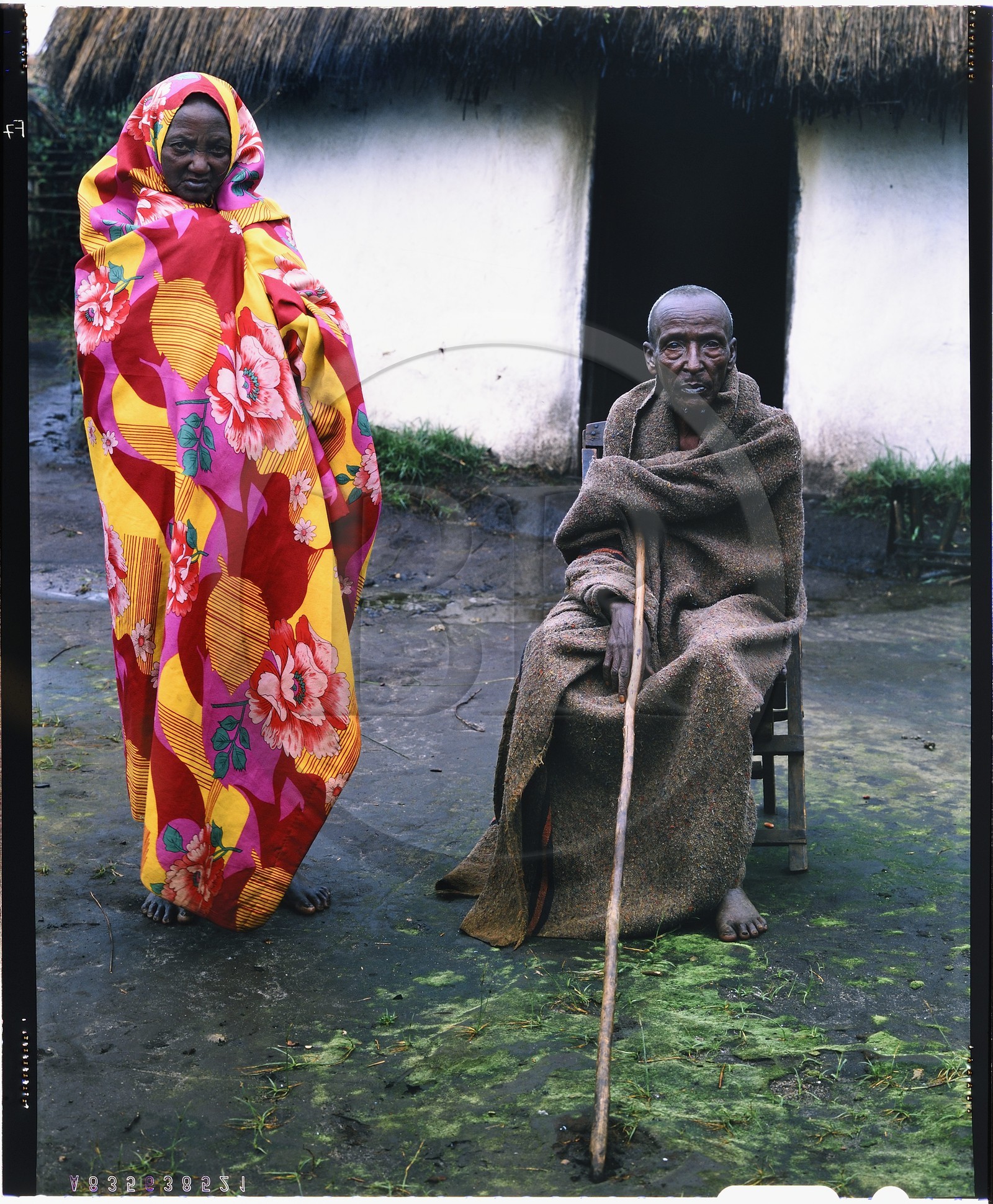 Burundi, Bujumbura Province, Ijenda area, Tutsi pastoralists old couple in front of their hut (4x5 reversal film reproduction)