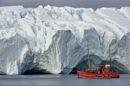 Greenland, west coast, Disko Bay, Ilulissat, icefjord listed as World heritage by UNESCO that is the mouth of the Sermeq Kujalleq Glacier, old fishing boat converted for iceberg discovery and whale watching