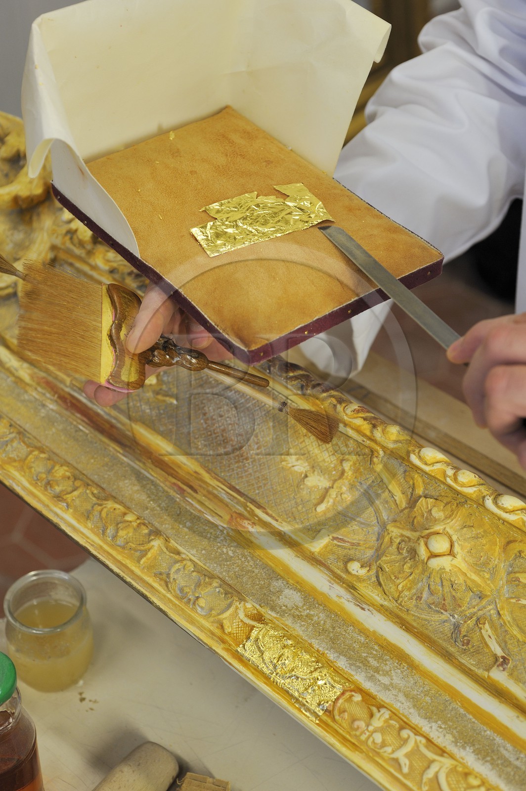 France, Yvelines, Chateau de Versailles, the castle restoration workshop, gilt workshop, Laurent Hissier working on a frame