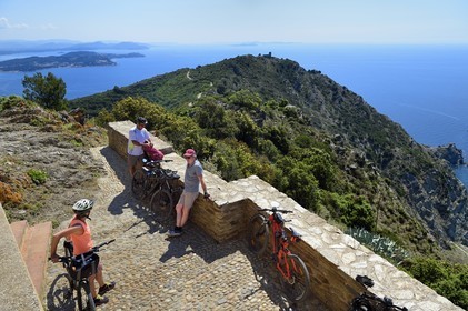 France, Var, La Seyne sur Mer, hike in the Cap Sicie massif, cyclists at the Notre-Dame du Mai chapel, the old semaphore of the cape, the peninsula of Saint mandrier left, the peninsula of Giens and the islands of Hyères in the background