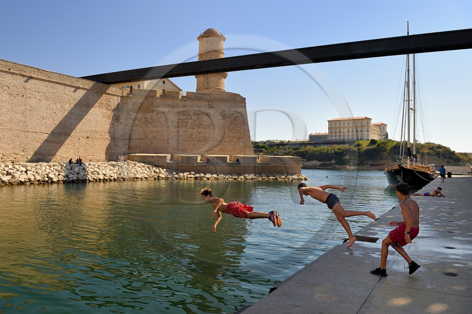 France, Bouches du Rhone, Marseille, La Joliette district, swimming area for neighborhood children at the foot of Fort Saint Jean linked to the MuCEM (Museum of Civilizations of Europe and the Mediterranean) by a bridge, Palais du Pharo in the background