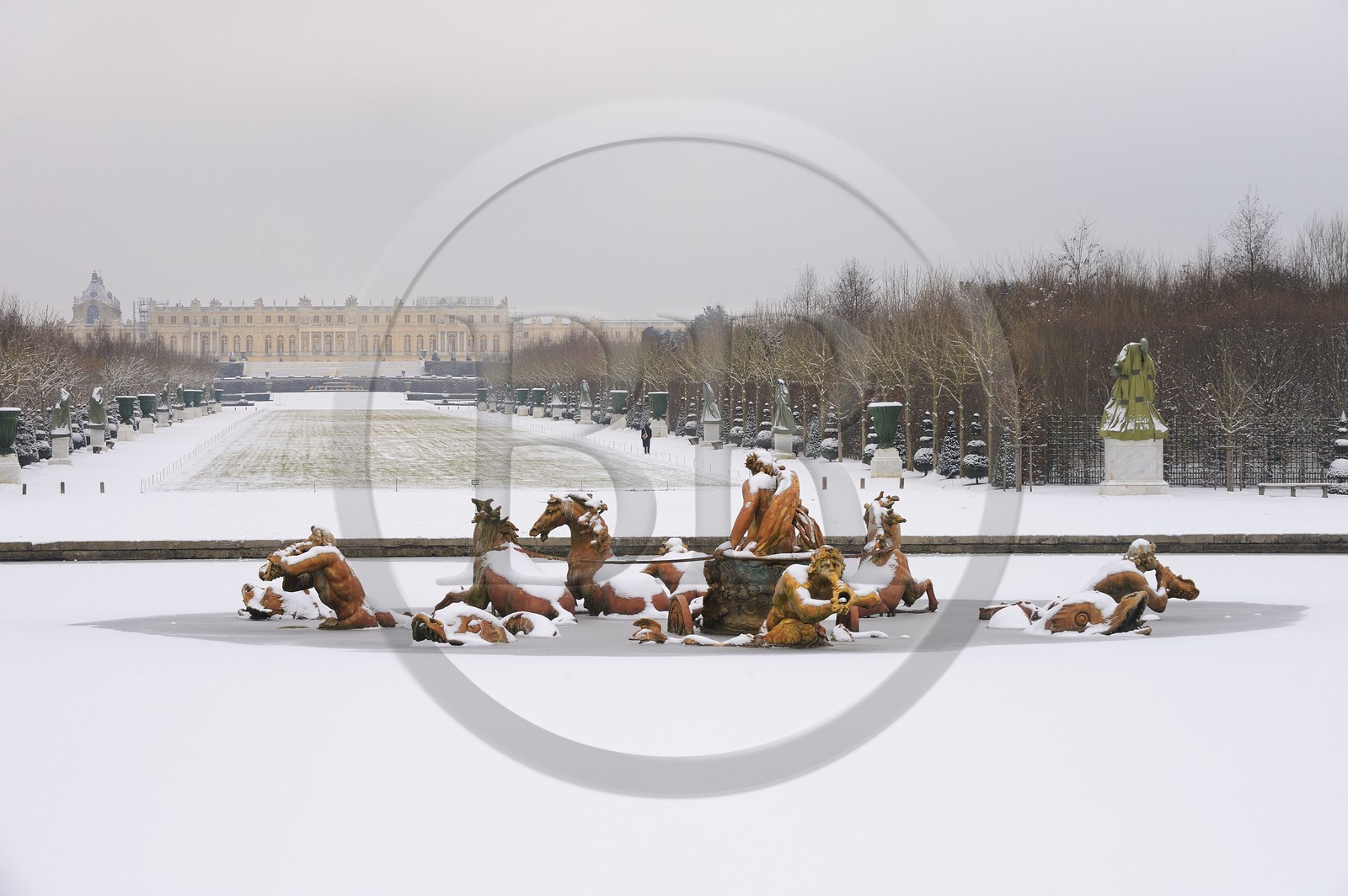 France, Yvelines, snow covered park of the Chateau de Versailles, listed as World Heritage by UNESCO, Apollo Basin by Tuby with the Apollo's Cart and Axe du Soleil (the Sun Axis) to the castle