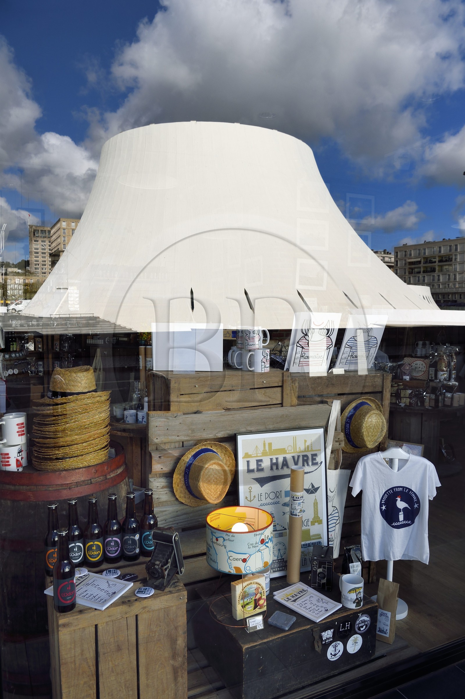 France, Seine Maritime, Le Havre, Downtown rebuilt by Auguste Perret listed as World Heritage by UNESCO, the cultural center called Volcano created by Oscar Niemeyer is reflected in the shop window LoHo The Local sHop