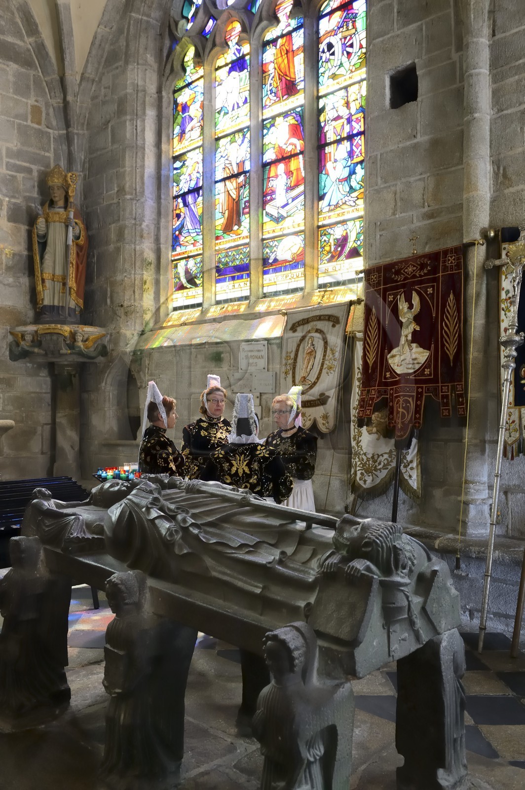 France, Finistere, Locronan, labelled Les plus Beaux Villages de France (The Most Beautiful Villages of France), women in traditional costume during the Tromenie around the cenotaph of St Ronan in Peniti chapel adjacent to the Saint Ronan church