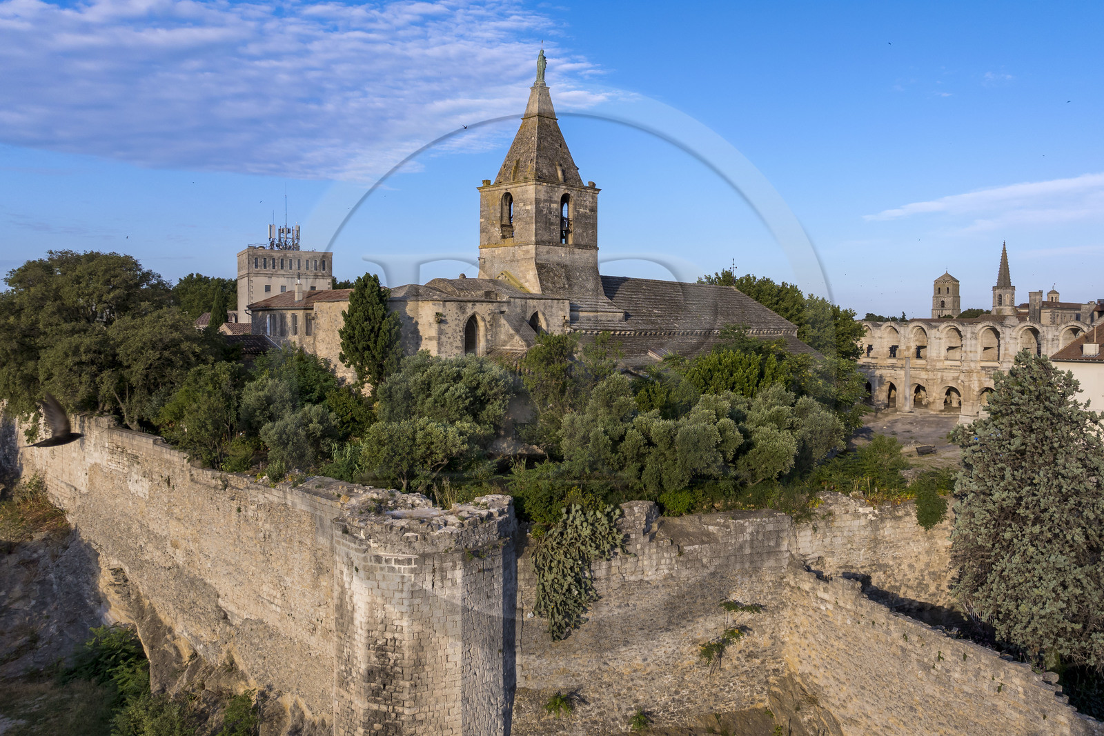 France, Bouches du Rhone, Arles, the ramparts listed as World heritage by UNESCO, remains of the surrounding walls of the ancient castrum of the Roman colony of Arelate dating from the 1st century and the Notre-Dame-de-la-Major church (aerial view)