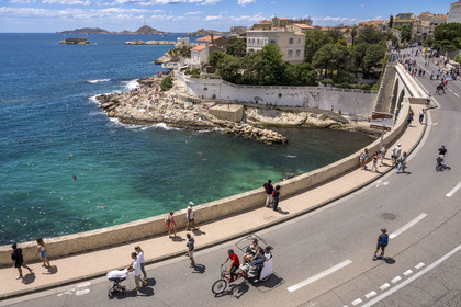 France, Bouches du Rhone, Marseille, Endoume district, the white rock beach of Petit Nice going from the cove of Fausse-monnaie to the cove of Maldormé, the small fort of Degaby Island and the Frioul Islands Archipelago with the Chateau d'If (on the right) in the background, President John Fitzgerald Kennedy's Corniche pedestrianized one Sunday a month in the foreground
