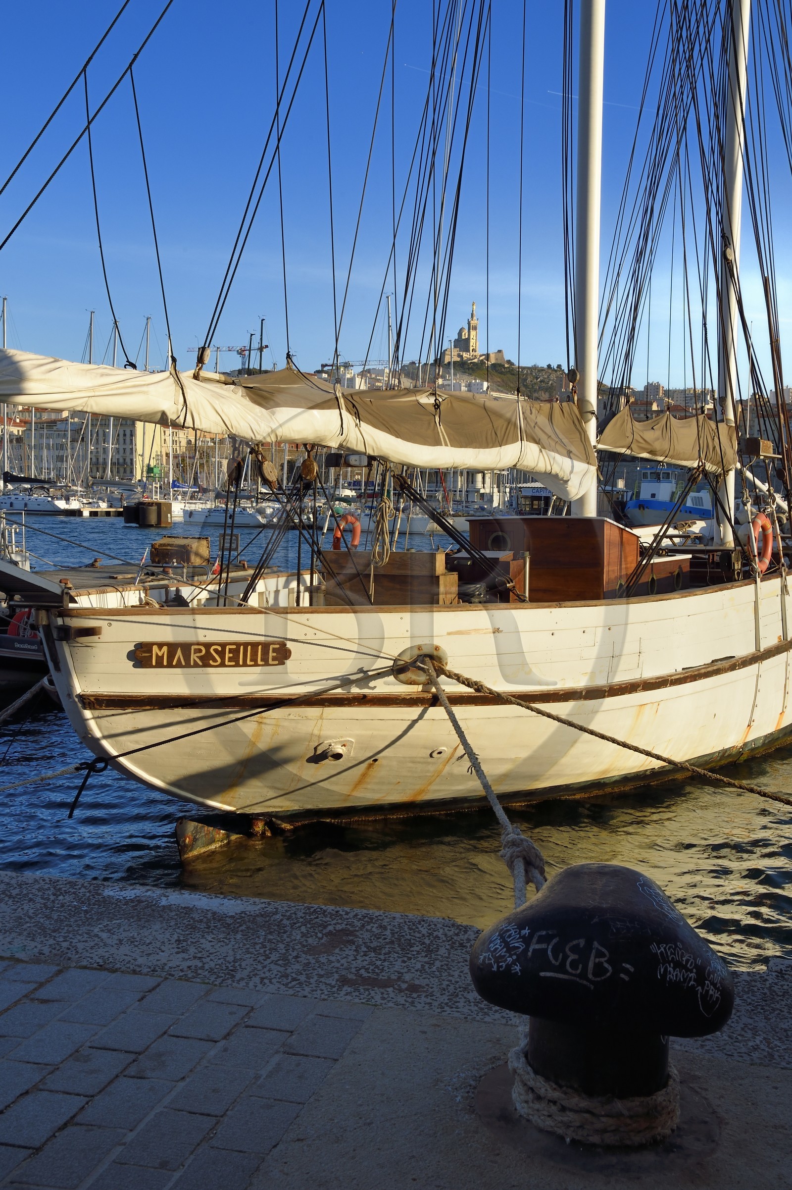 France, Bouches du Rhone, Marseille, the Vieux Port, the Marseille sailboat and Notre Dame de la Garde in the background