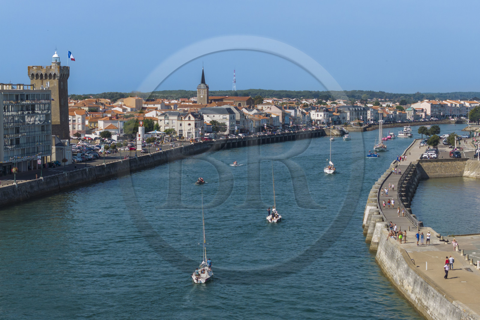 France, Vendee, Les Sables d'Olonne, boats in the access channel to the ports, the La Chaume district on the left with the 14th century Arundel Tower, a former keep converted into a lighthouse and maritime museum (aerial view)