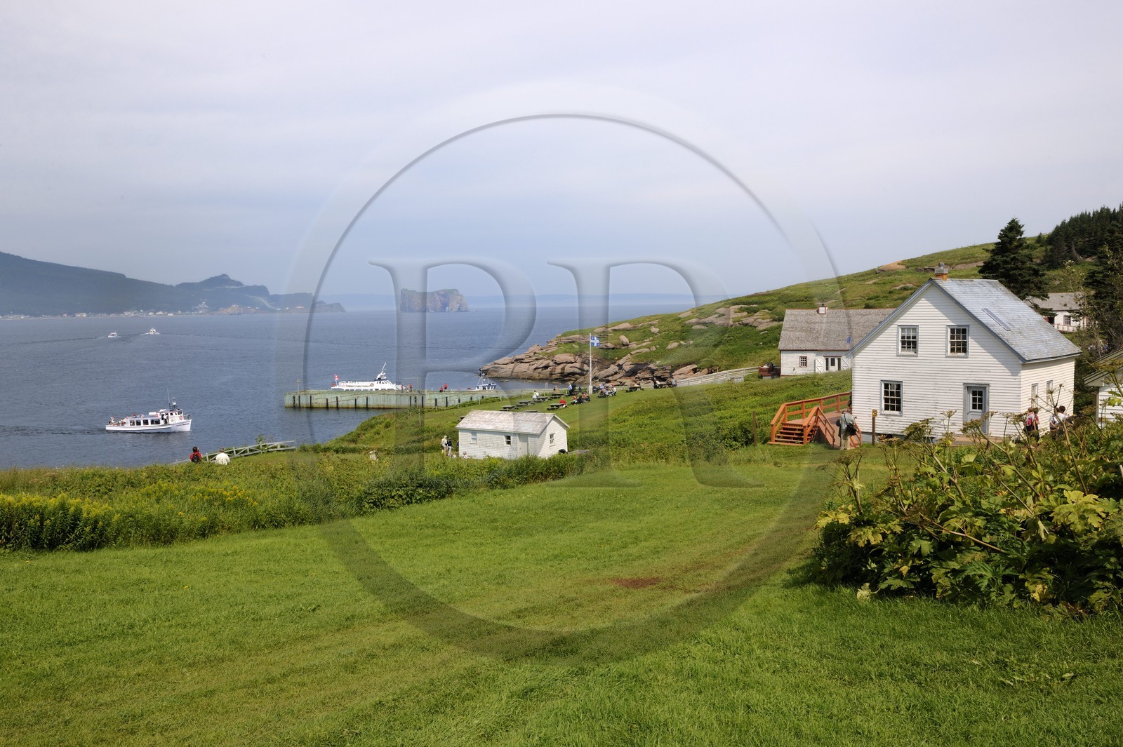 Canada, Quebec Province, Gaspesie, Ile Bonaventure (Bonaventure Island), coastal village of wooden houses and the Rocher Perce (Perce Rock)