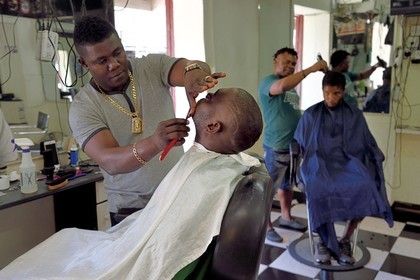 Caribbean, Dominica Island, the capital city Roseau, French Quarter, men's hair salon on the main street Great George Street