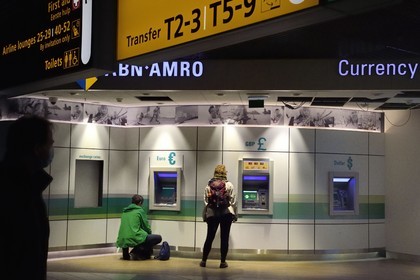 Holland, Amsterdam, Schiphol airport, cash machine in euros €, pounds sterling £ and dollars $