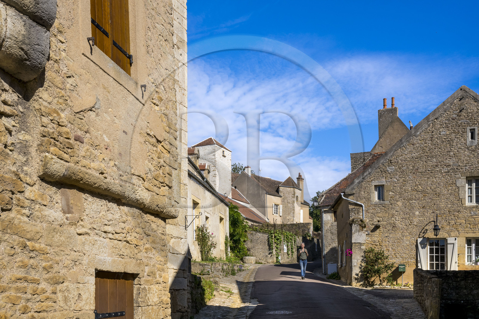 France, Yonne, Montreal (Burgundy), hiker going down the Grand-Rue