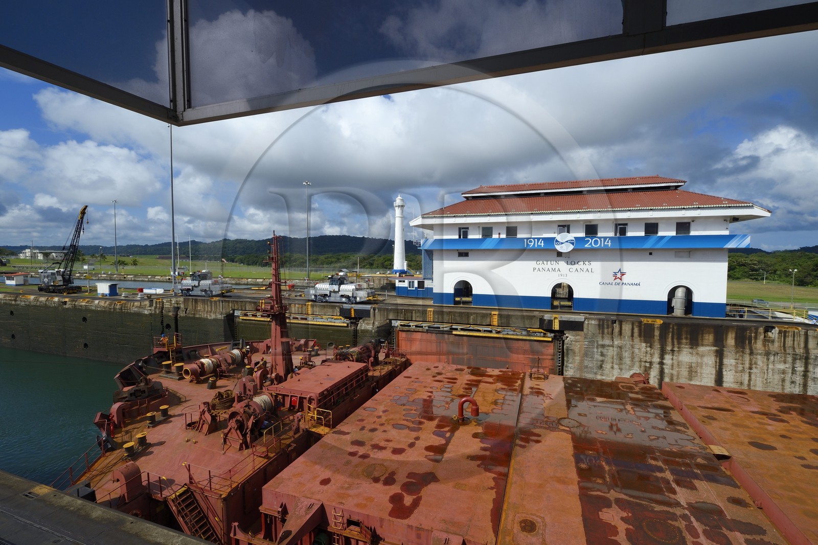 Panama, Colon province, Panama Canal, Gatun locks, mechanical mules or electric locomotives guiding a Panamax cargo between the lock walls