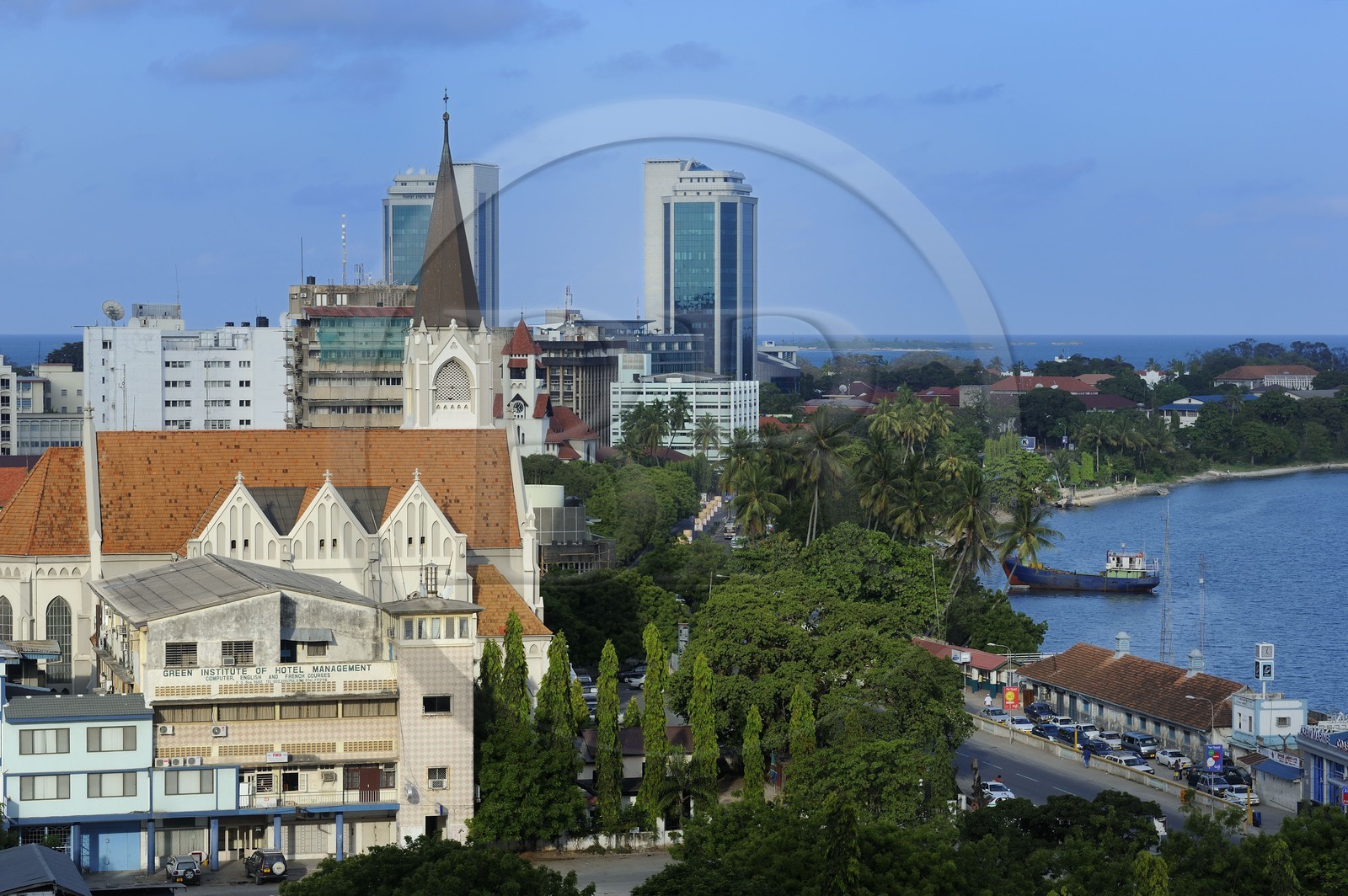 Tanzania, Dar es-Salaam, St Joseph cathedral on the waterfront, in the back the twin towers of the Bank of Tanzania