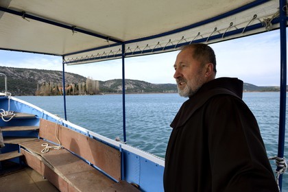 Croatia, Dalmatia, Krka National Park where Krka River becomes Lake Visovac, the Visovac Franciscan Monastery on the island, Brother Stojan