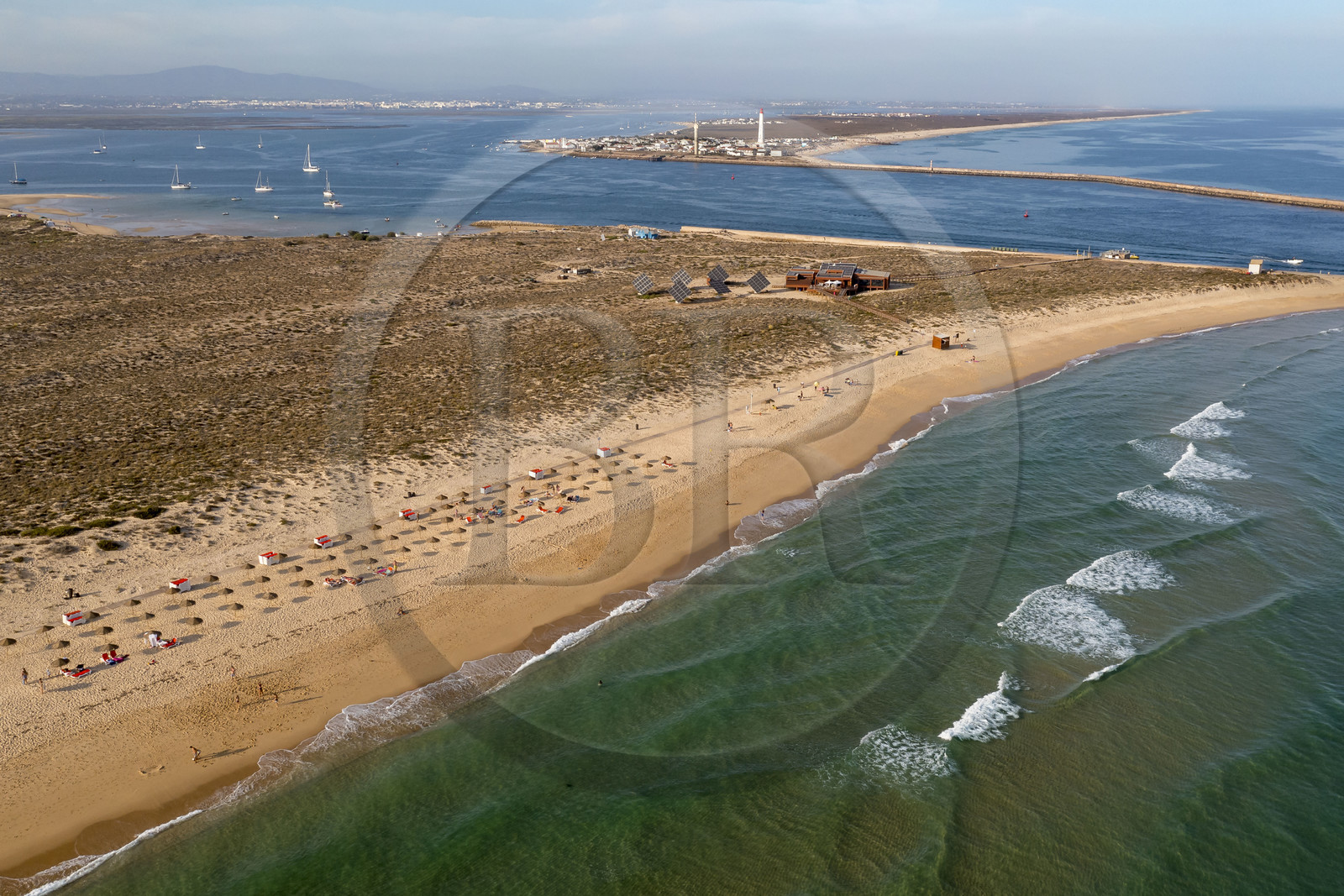 Portugal, Algarve, Ria Formosa Natural Park, Faro, Island of Barreta or Deserta (Ilha da Barretta or Deserta), the lighthouse of Ilha do Farol part of  Ilha da Culatra in the background (aerial view)