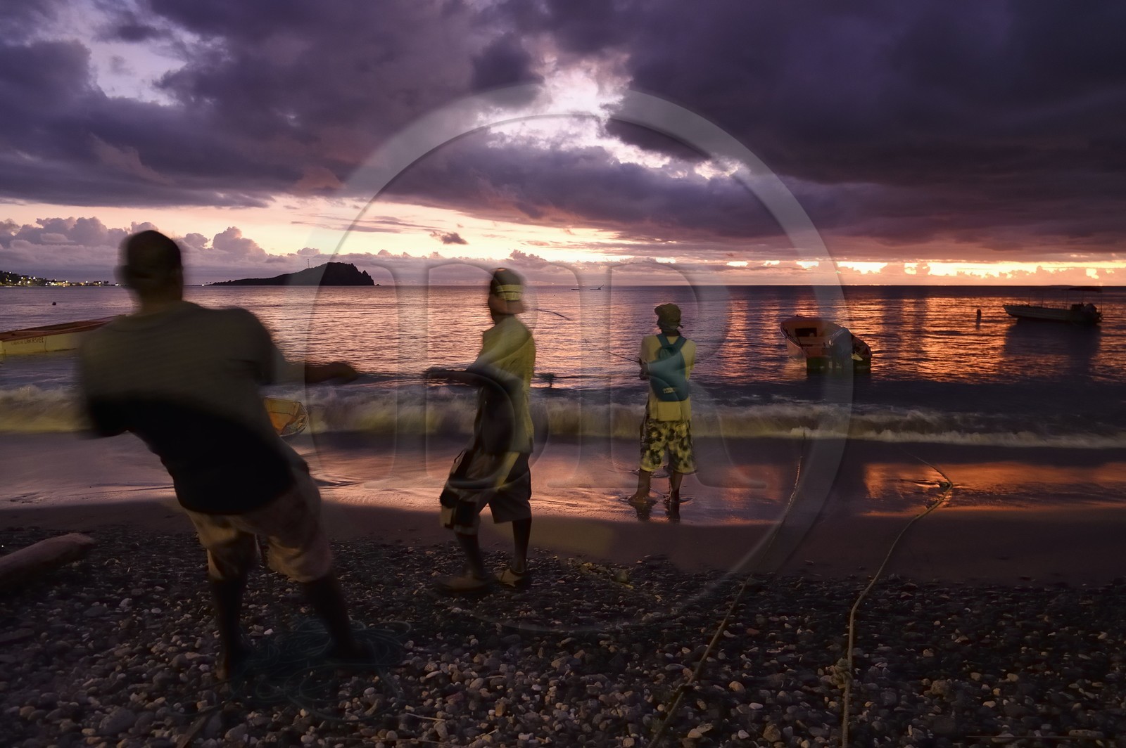 Caribbean, Dominica Island, Soufriere Bay, the village of Soufriere, beach-side net fishing at dusk