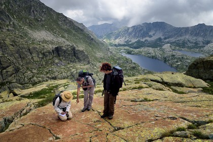 France, Alpes-Maritimes, parc national du Mercantour (Mercantour National Park), the Vallee des Merveilles (Valley of Wonders) scattered with thousands of rupestral engravings of the Bronze Age, the chiappes yellow schist flagstones, hornlike figures observation in the company of archaeologist Nicoletta Bianchi