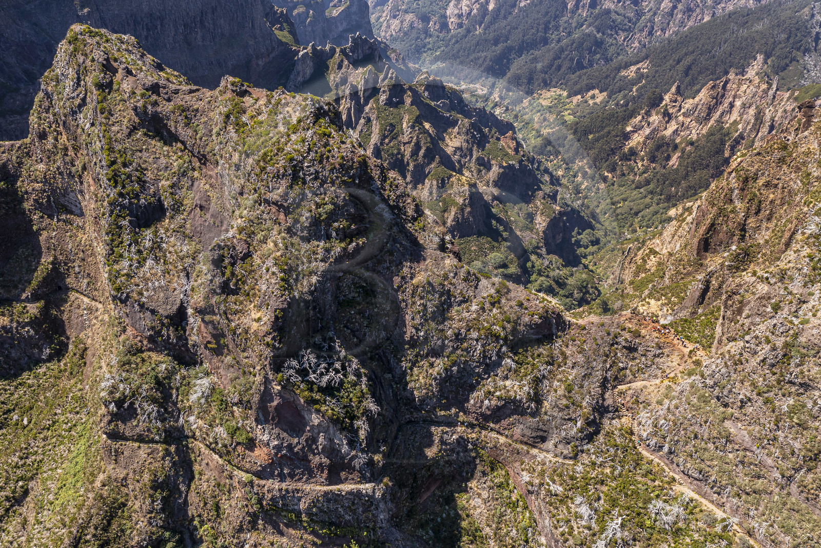 Portugal, Madeira Island, Vereda do Areeiro hike between Pico Ruivo (1862m) and Pico Arieiro (1817m), hikers crossing Pico Das Torres (aerial view)