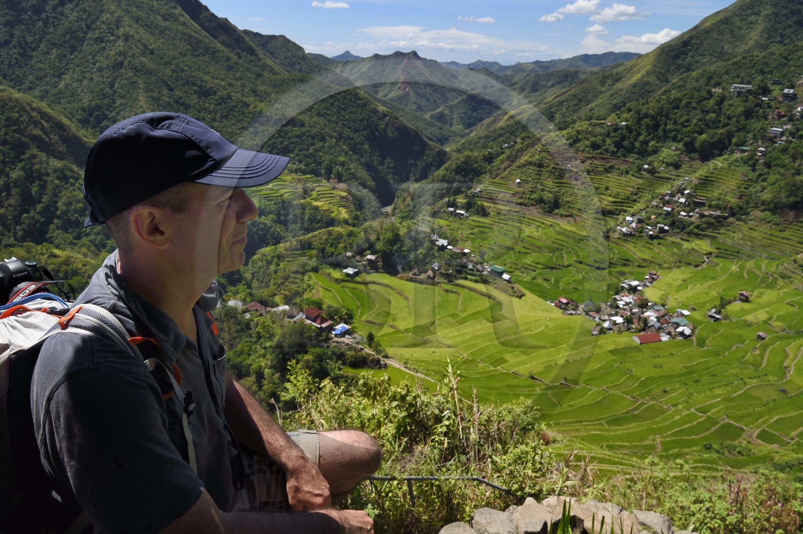Philippines, Ifugao province, hiker overlooking Banaue rice terraces around the village of Batad, listed as World Heritage by UNESCO