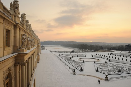 France, Yvelines, snow covered park of the Chateau de Versailles, listed as World Heritage by UNESCO, Midi bed at sunset
