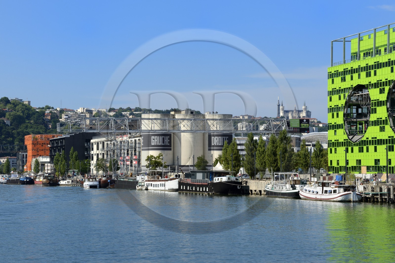 France, Rhône (69), Lyon, nouveau quartier de La Confluence au sud de la Presqu'île, Quai Rambaud, la Sucrière ancien entrepôt des années 1930 accueille depuis 2003 la biennale d'art contemporain en arrière plan et le batiment vert siège d'Euronews sur la droite