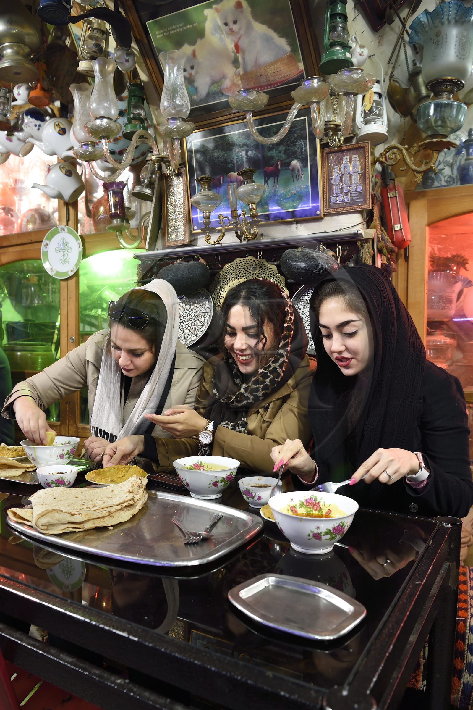 Iran, Isfahan Province, Isfahan, Chai Khaneh Azadegan Tea House and restaurant, young iranian women student in medical engineering whose name are, from left to right, Pita, Nadia and Niloufar (no model release)